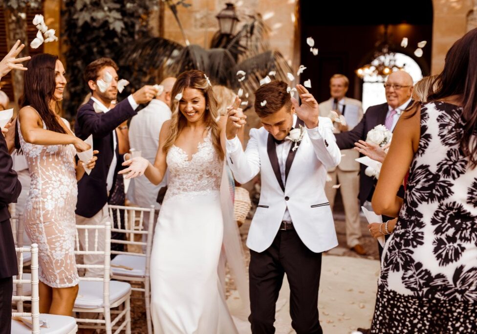 A couple are seen walking down the aisle after their wedding ceremony in Mallorca