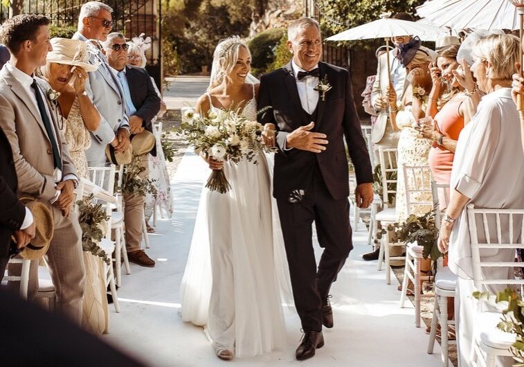 A bride and her father walk down the aisle