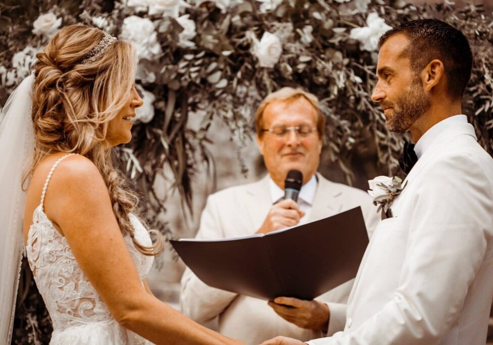 The couple are holding hands and exchanging their vows